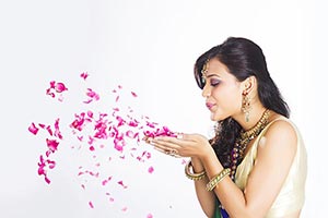 Indian Beautiful Woman Blowing Rose