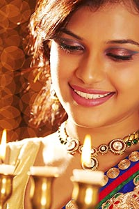 Woman Lighting Diwali Lamp