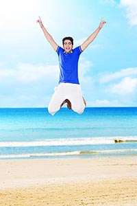 1 Person Only ; 20-25 Years ; Arms Raised ; Beach 