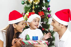 Boy Receiving Christmas Gift Parents Smiling