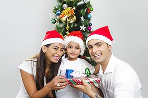 Parents giving his son gift at christmas Celebrati