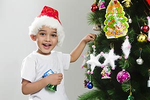 Kid Boy Festival decorating Christmas tree Smiling