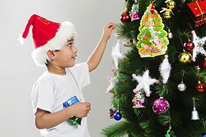 Kid Boy Festival decorating Christmas tree Smiling