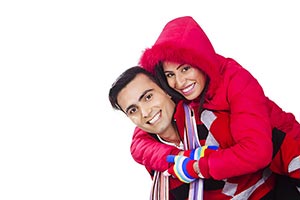 couple winter clothes playing piggyback Fun Smilin