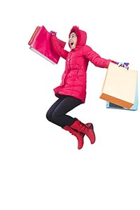 Cheerful Woman carrying shopping bags jumping mid 