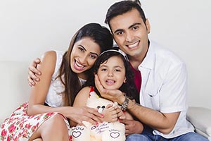 Parents Girl Sitting Sofa At Home Smiling Enjoy