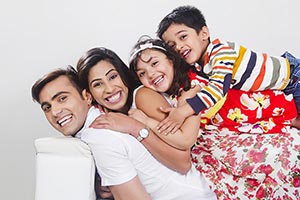 Parents Kids Lying Sofa At Home Enjoy Smiling