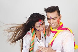 Couple Holi Celebration Fun Reading Messaging Cell