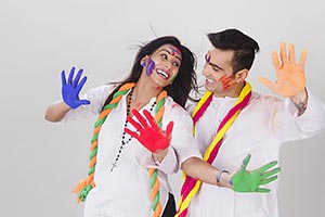 Indian Couple showing colored hands Holi festival