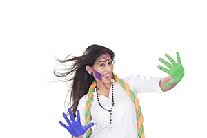 Excited Woman showing colored hands Holi Celebrati