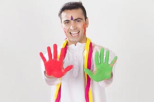Excited man showing colored hands Holi Celebration