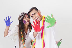 Cheerful Couple showing colored hands Holi Celebra