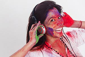 Woman Holi Celebrating listening music headphone