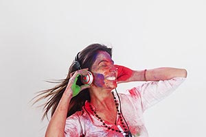 Woman Holi Celebrating listening music headphone E