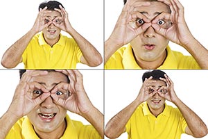 Montage Photo Man Looks Through Finger Binoculars