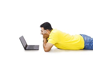 Man Lying Floor Reading Laptop