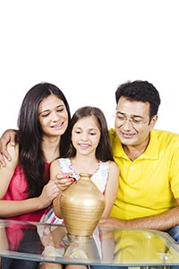 Parents Daughter Inserting Coin Piggybank