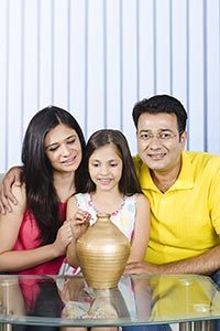Indian Family Putting Coin Piggybank