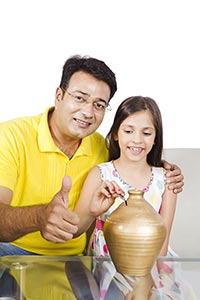 Father Daughter Putting Coin Piggybank Thumbsup