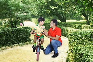 Father Teaches Son Ride Bike Park