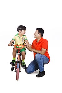 Father Teaching Son Ride Bicycle