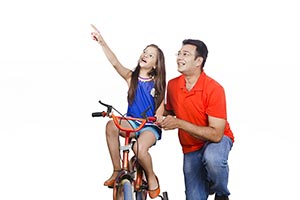 Father Teaching Daughter Ride Bicycle Pointing