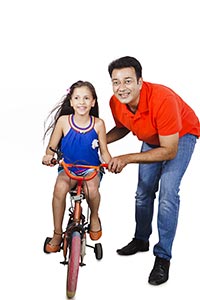 Father Teaching Daughter Ride Bicycle