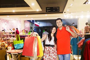 Happy Indian Couple Holding Shopping Bags