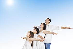 Family Standing Outdoors Arms Outstretched