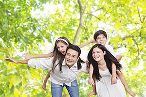 Parents Giving Piggyback Ride Children Park