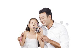 Mother Father Daughter Blowing Bubbles