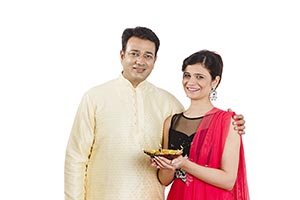 Couple Celebrating Diwali Lighting Diya