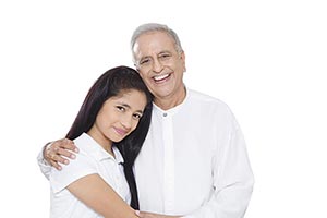 Grandfather Hugging Teenage Granddaughter