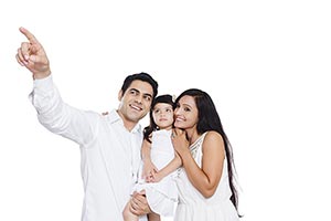 Parents Carrying Daughter Arms Pointing