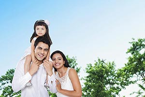 Mother Father Carrying Daughter Shoulders Outdoors