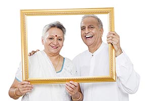 Senior Couple Holding Photo Frame