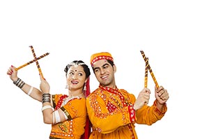 Indian Gujarati Couple Performing Dandiya Dance