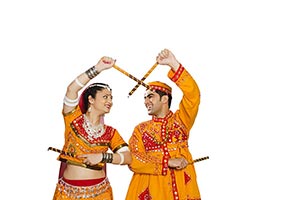 Couple Traditional Wear Performing Dandiya Raas