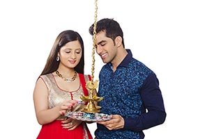 Indian Couple Lighting Diwali Lamp Smiling