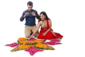 Married Couple Diwali Rangoli Clicking Photo