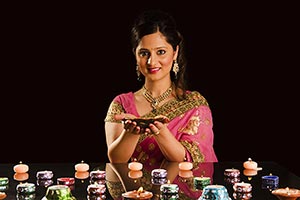 Indian Woman Lighting Diya Celebrating Diwali