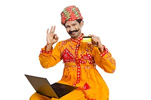 Gujrati Man Laptop Showing Credit card