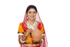 Gujrati Woman Inserting Coin Piggybank