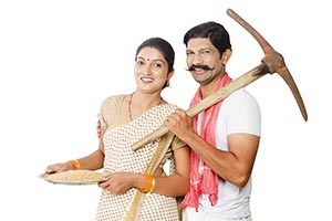 Rural Couple Holding Digging Tools