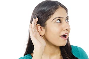 Young Woman Cupping hand Eavesdropping