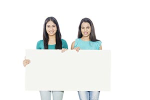 Teenage Girls Holding White board