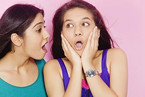 Girl Telling Secret Shocked Sister