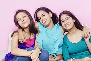 Teenage Girls Sitting Sofa