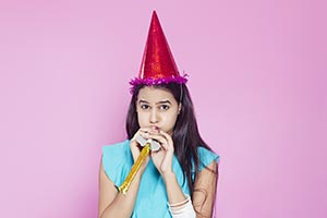 Girl Blowing Party Horn