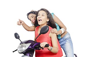 Teenage Girls Riding Scooty